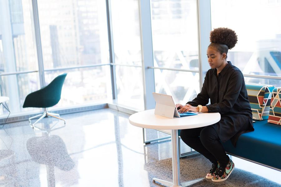 One person working at a laptop by a window